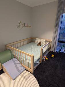 Picture of a bed base on the floor with dowel rails