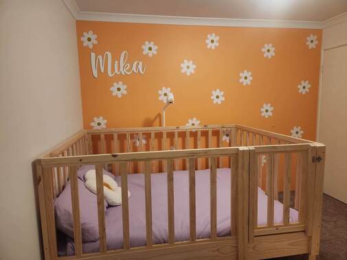 Picture of bed base off the floor, with high rails and a gate