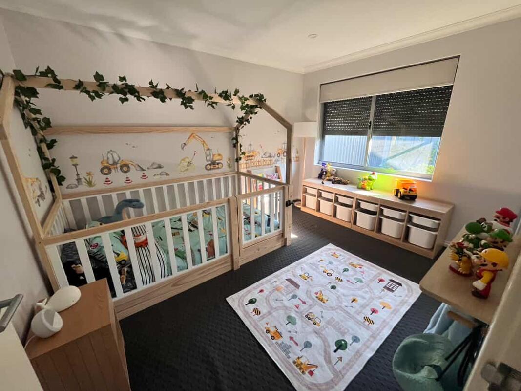 Picture of a house bed on the floor with white rails