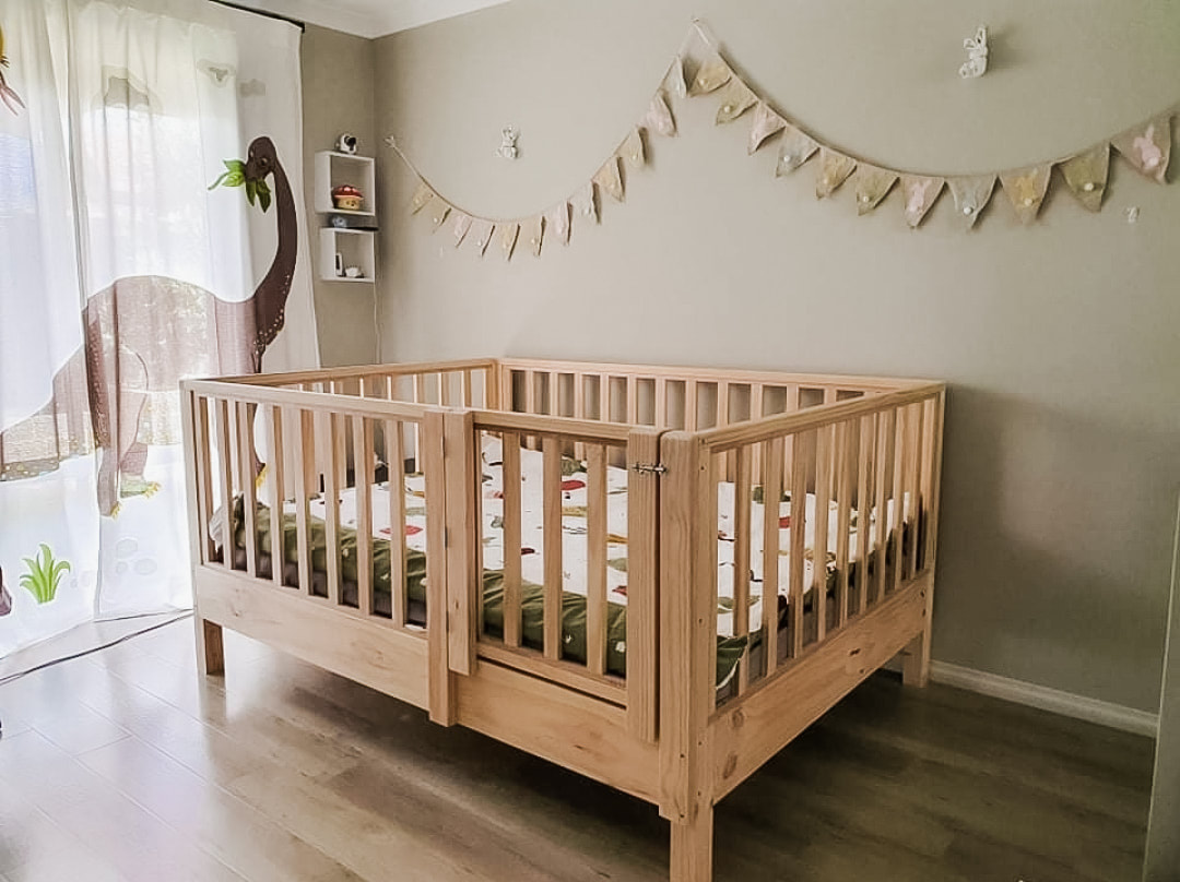 Picture of bed base off the floor, with high rails and gate